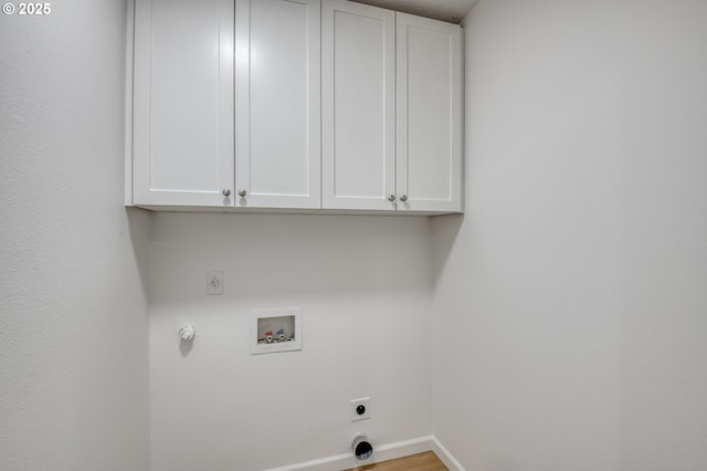 clothes washing area with hookup for a washing machine, cabinet space, baseboards, and hookup for an electric dryer