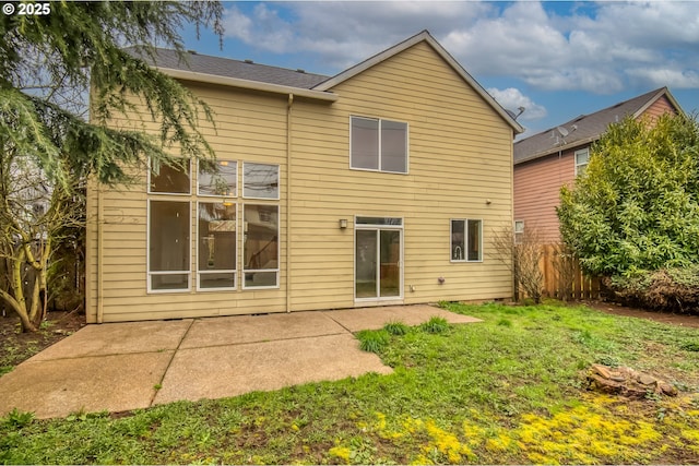 rear view of property with a patio area, fence, and a lawn