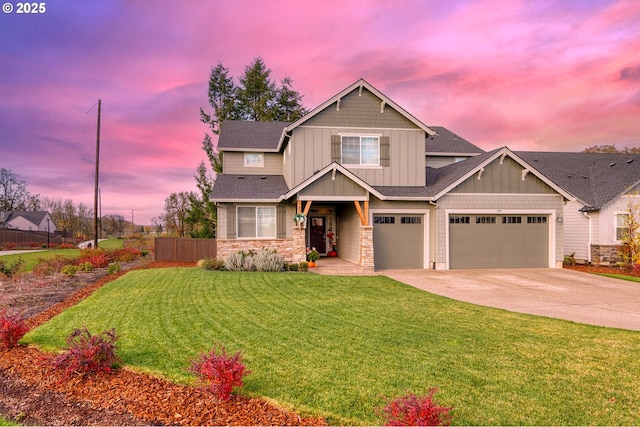 craftsman-style home featuring driveway, stone siding, fence, board and batten siding, and a front yard