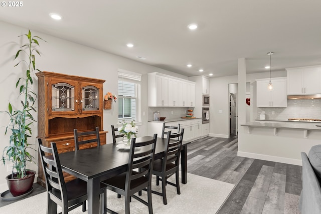 dining space with baseboards, dark wood finished floors, and recessed lighting