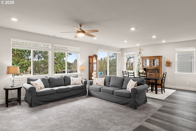 living area with baseboards, ceiling fan, dark wood finished floors, and recessed lighting