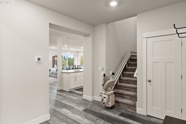 staircase with recessed lighting, wood finished floors, and baseboards