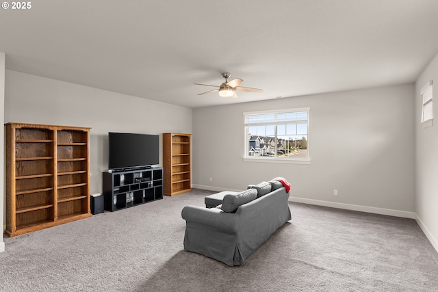 living room with carpet floors, baseboards, and a ceiling fan