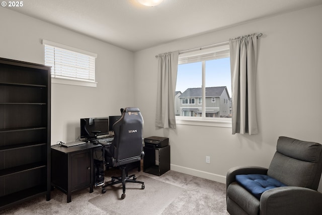 home office with light carpet, plenty of natural light, and baseboards