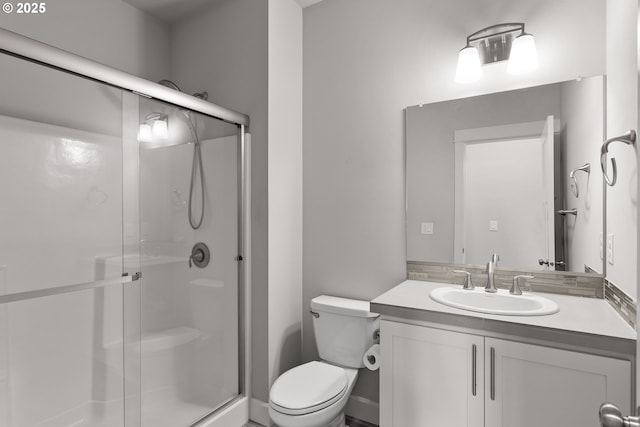 full bath featuring toilet, a shower stall, and vanity