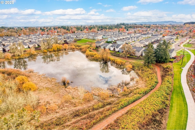 birds eye view of property with a water view and a residential view