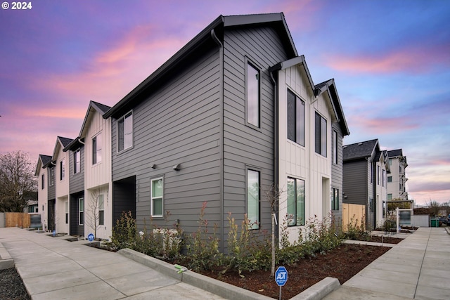 property exterior at dusk with a residential view