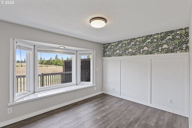 33549 Wikstrom Rd, Scappoose, OR 97056 - unfurnished room featuring wallpapered walls, wood finished floors, and a wainscoted wall