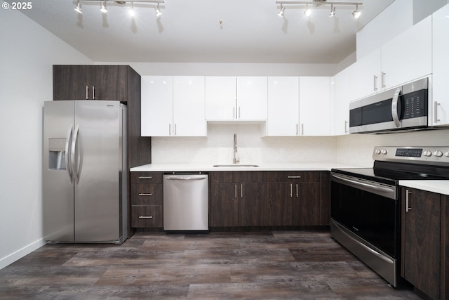 kitchen featuring white cabinets, appliances with stainless steel finishes, sink, and dark brown cabinets