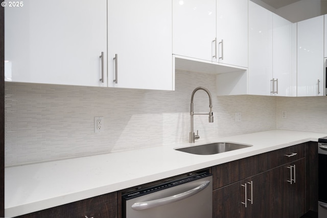 kitchen featuring dishwasher, white cabinets, tasteful backsplash, and sink