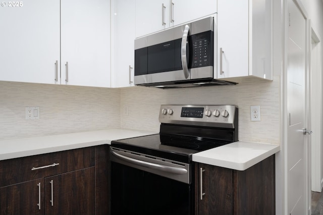 kitchen featuring backsplash, white cabinetry, stainless steel appliances, and dark brown cabinets