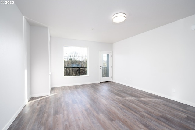 spare room featuring dark hardwood / wood-style floors