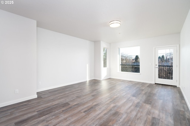 empty room with dark hardwood / wood-style floors