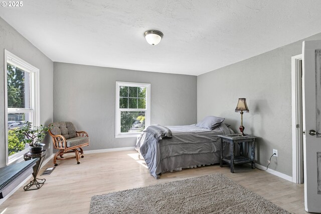 1112 S 6th St, Cottage Grove, OR 97424 - bedroom featuring light wood-style flooring and a textured ceiling