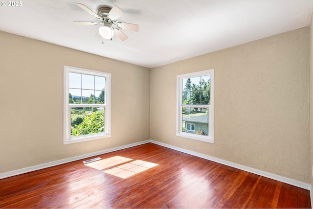 1112 S 6th St, Cottage Grove, OR 97424 - spare room featuring healthy amount of natural light, wood finished floors, a ceiling fan, and a textured wall