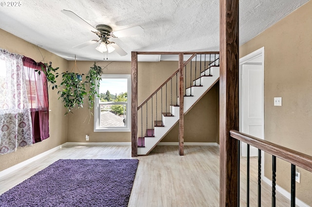 1112 S 6th St, Cottage Grove, OR 97424 - foyer entrance featuring wood finished floors, a ceiling fan, a textured ceiling, and stairway