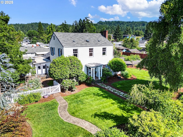 1112 S 6th St, Cottage Grove, OR 97424 - back of property with a wooded view, a chimney, and a shingled roof
