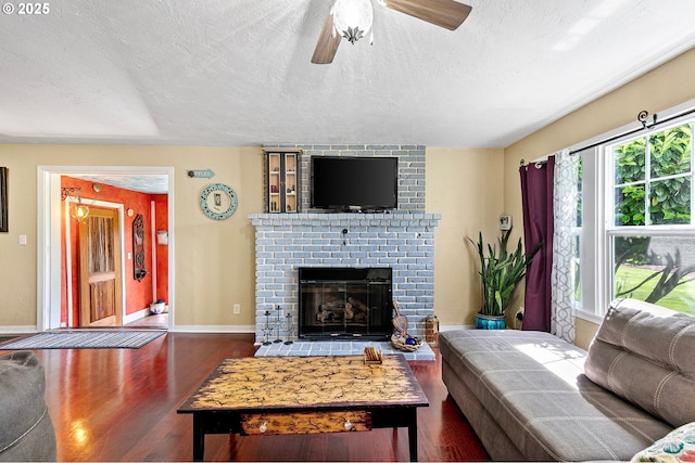1112 S 6th St, Cottage Grove, OR 97424 - living area featuring a textured ceiling, wood finished floors, ceiling fan, and a fireplace