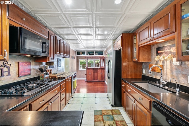 1112 S 6th St, Cottage Grove, OR 97424 - kitchen featuring black appliances, an ornate ceiling, dark countertops, brown cabinets, and glass insert cabinets
