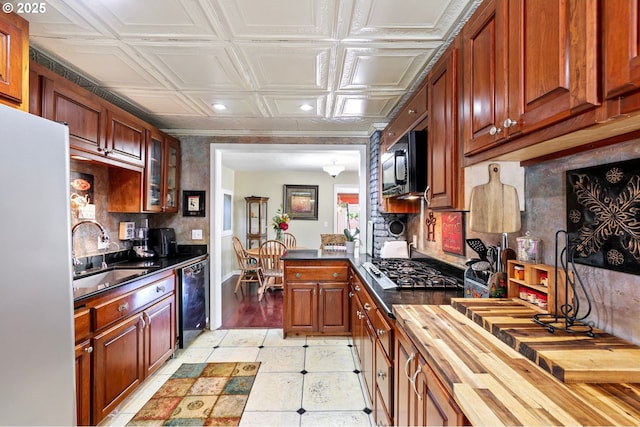 1112 S 6th St, Cottage Grove, OR 97424 - kitchen with black appliances, wood counters, decorative backsplash, recessed lighting, and an ornate ceiling
