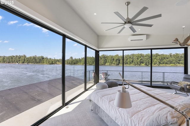 3939 N Marine Dr Unit 12, Portland, OR 97217 - bedroom featuring a wall mounted air conditioner, a water view, recessed lighting, and view of wooded area