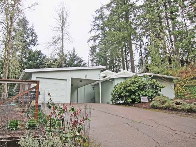 exterior space featuring concrete driveway, a carport, and stucco siding