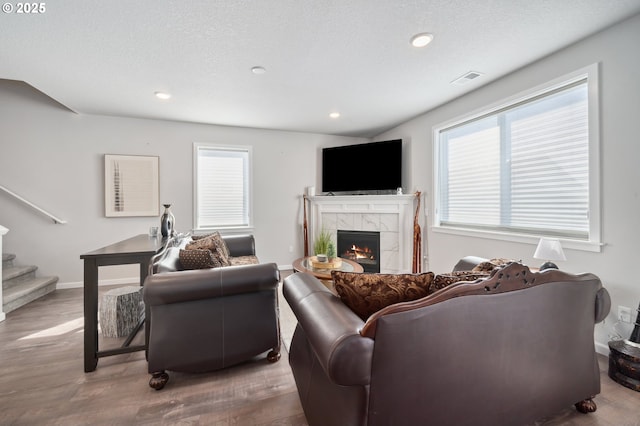 1540 19th Ave, Forest Grove, OR 97116 - living area with wood finished floors, a tiled fireplace, healthy amount of natural light, stairs, and recessed lighting