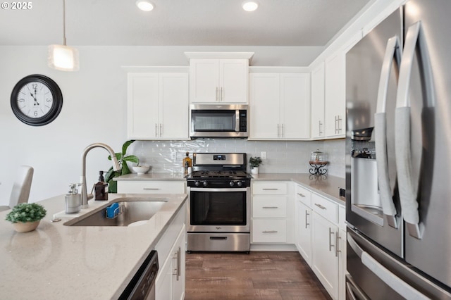 1540 19th Ave, Forest Grove, OR 97116 - kitchen featuring appliances with stainless steel finishes, light stone counters, dark wood-style flooring, white cabinetry, and recessed lighting