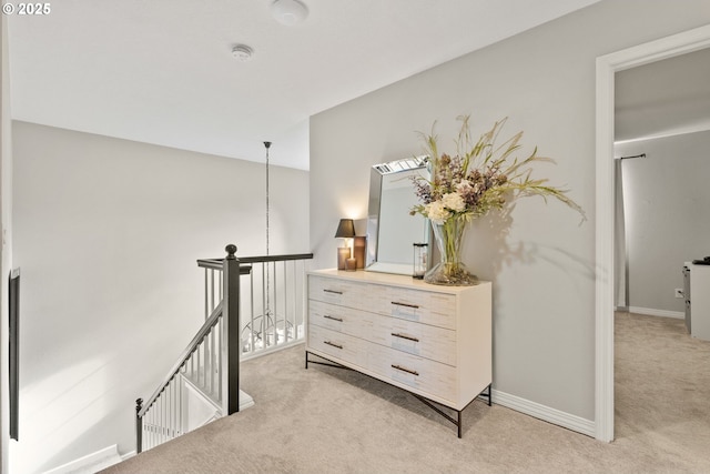 hall with light colored carpet