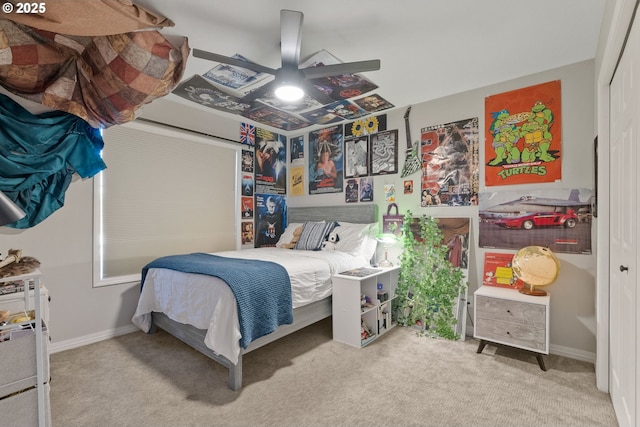 carpeted bedroom with ceiling fan and a closet