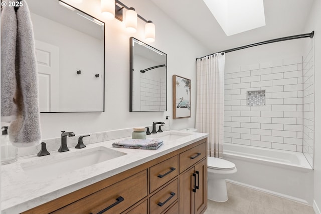 full bathroom featuring shower / tub combo with curtain, tile patterned floors, toilet, a skylight, and vanity