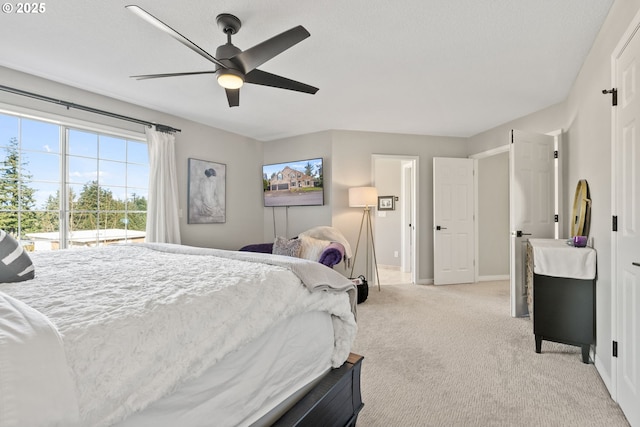 bedroom featuring ceiling fan, access to exterior, and light carpet