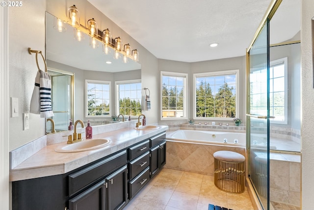 bathroom with vanity, tile patterned flooring, plenty of natural light, and independent shower and bath