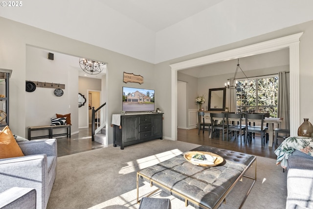 carpeted living room featuring a chandelier and a high ceiling