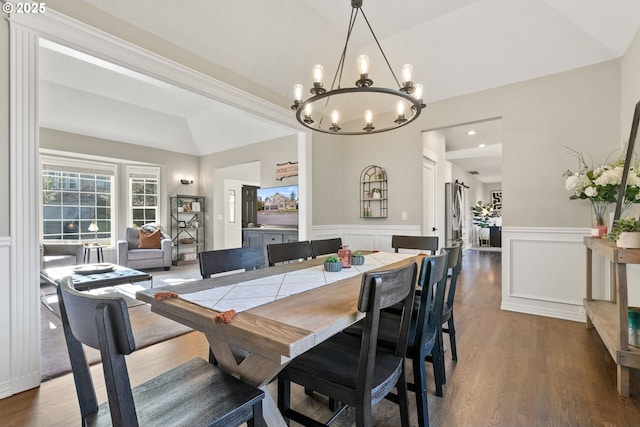 dining room featuring lofted ceiling and dark wood-type flooring