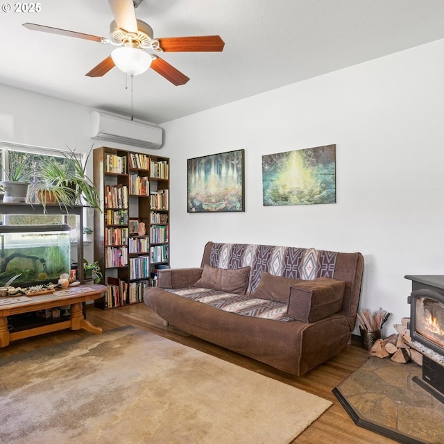 1104 Upper Cow Creek Rd, Azalea, OR 97410 - living area with a wall unit AC, wood finished floors, a wood stove, and a ceiling fan