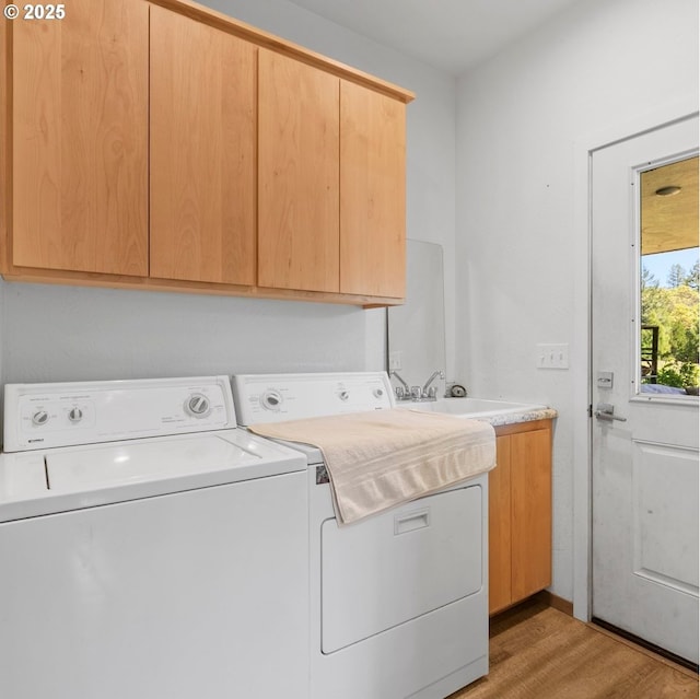 1104 Upper Cow Creek Rd, Azalea, OR 97410 - laundry room with washer and clothes dryer, cabinet space, and light wood finished floors