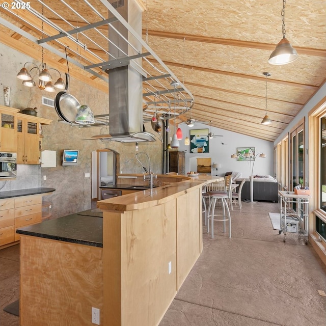 1104 Upper Cow Creek Rd, Azalea, OR 97410 - kitchen featuring light brown cabinetry, dark countertops, open floor plan, island exhaust hood, and oven
