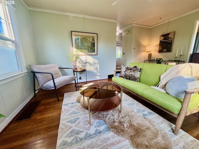 living room featuring wood-type flooring and ornamental molding