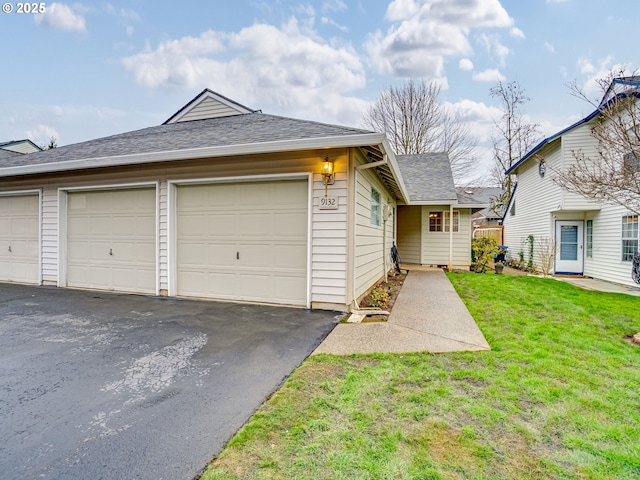 ranch-style home with a garage and a front yard