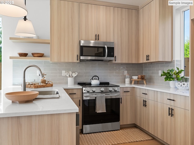 1212 SE Center St Unit 6, Portland, OR 97202 - kitchen featuring stainless steel appliances, light brown cabinetry, and modern cabinets