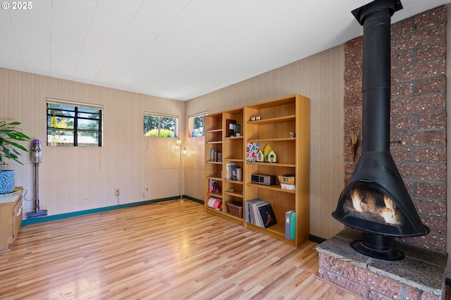 14511 NE Brazee Ct, Portland, OR 97230 - living area with a wood stove, wood finished floors, and baseboards