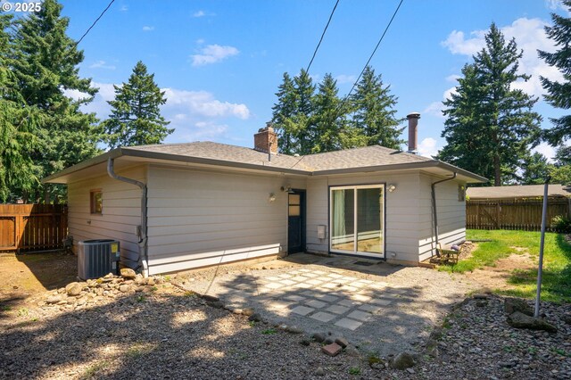 14511 NE Brazee Ct, Portland, OR 97230 - rear view of house featuring central air condition unit, a chimney, and a patio area