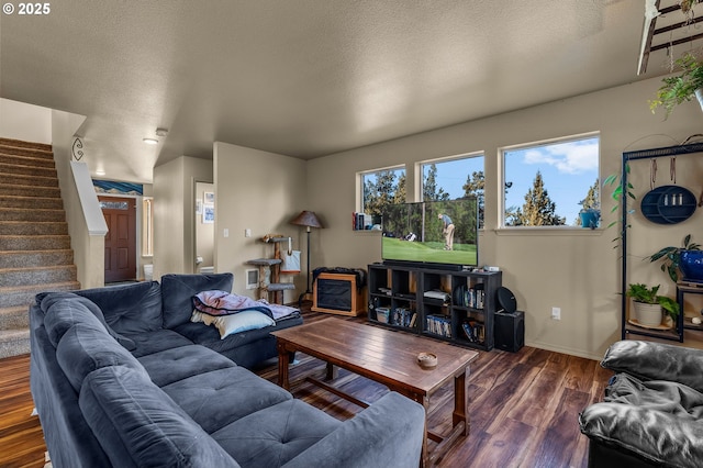 living room with dark hardwood / wood-style floors and a textured ceiling