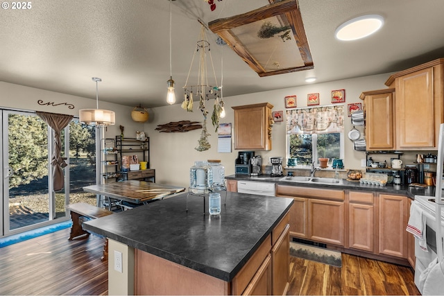 kitchen featuring a healthy amount of sunlight, sink, pendant lighting, and white appliances