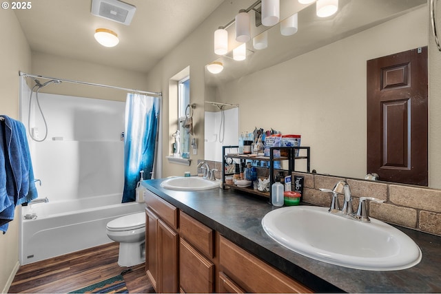 full bathroom featuring toilet, vanity, shower / bathtub combination with curtain, and hardwood / wood-style floors