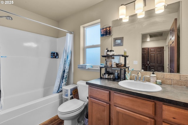 full bathroom with shower / bath combination with curtain, vanity, and toilet