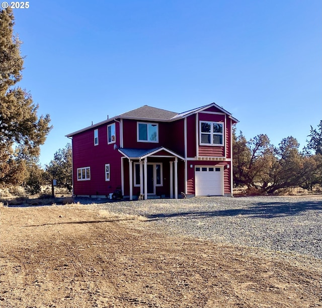 view of front property featuring a garage and covered porch