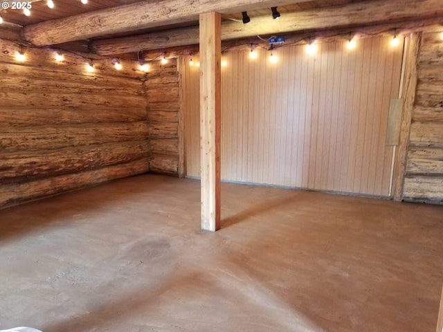 basement featuring wooden walls