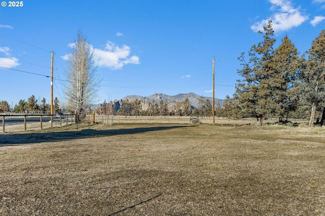 view of yard with a mountain view and a rural view